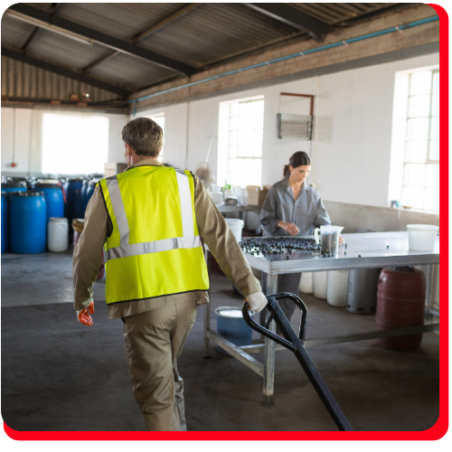 Industrial workers in a warehouse facility performing commercial water extraction and damage control operations.
