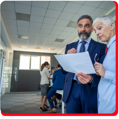 Professionals reviewing commercial property documents during an asbestos abatement consultation in a Toronto office environment.
