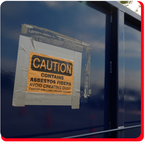Warning sign on blue industrial container indicating presence of asbestos fibers, used during commercial asbestos removal in Toronto.