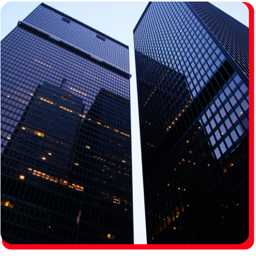Two towering glass skyscrapers in downtown Toronto viewed at dusk, highlighting the critical role of building envelope restoration in maintaining facade integrity and energy efficiency.