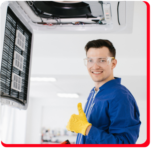 Restoration technician in safety gear giving a thumbs-up while inspecting HVAC equipment—representing professional catastrophe contents restoration services in Toronto following fire, flood, or major structural disasters.