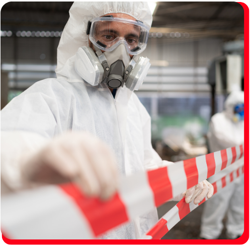 Hazmat professional in full protective gear securing a restricted area with caution tape during a chemical spill cleanup operation in Toronto.