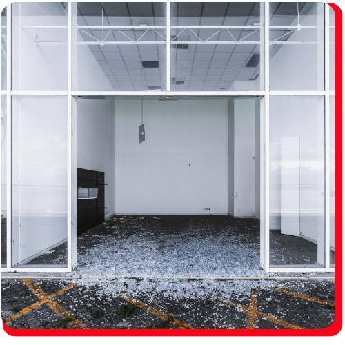 Vacant commercial storefront in Toronto, Ontario, with shattered glass scattered across the entrance, requiring professional damage assessment and restoration services.
