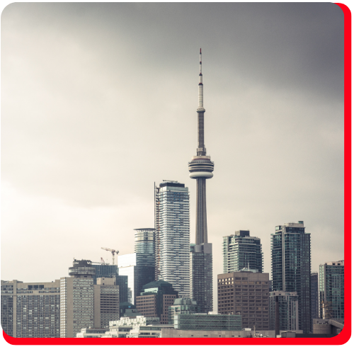 A dramatic view of the Toronto skyline under overcast skies, highlighting the vulnerability of commercial high-rises to storm damage and the need for rapid commercial storm restoration services.