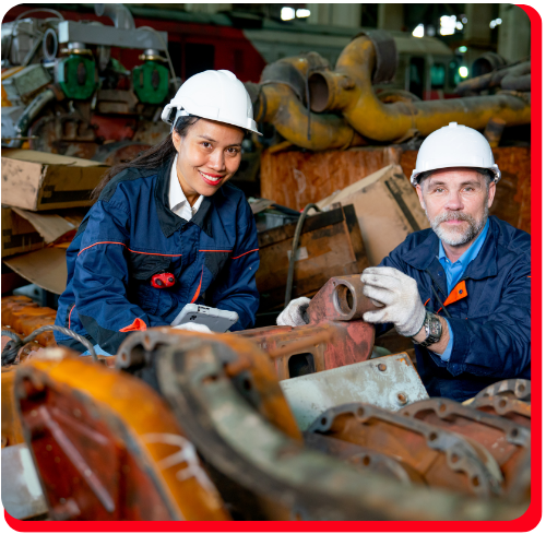 Two industrial workers in protective gear inspecting and salvaging damaged machinery after an industrial accident in a Toronto facility. Two industrial workers in protective gear inspecting and salvaging damaged machinery after an industrial accident in a Toronto facility.