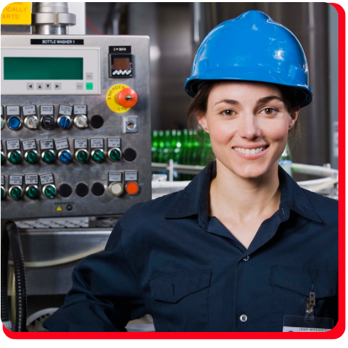Female technician in safety gear standing in front of a control panel, representing industrial accident cleanup and machinery restoration in a Toronto manufacturing facility.