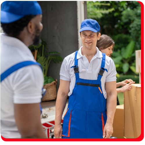Restoration crew in Toronto, Ontario, wearing blue uniforms and caps, preparing for pack out services by loading items into a truck as part of a disaster recovery and restoration project.