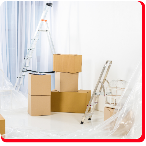 Cardboard boxes, ladders, and covered furniture in a bright Toronto, Ontario room prepared for pack out restoration and disaster recovery services.