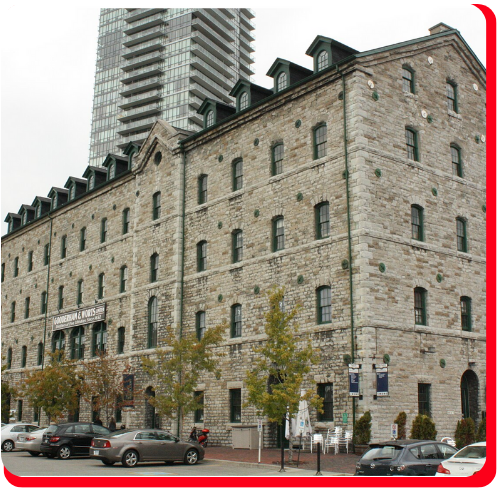 Historic multi-story stone building in Toronto, Ontario, Canada, showcasing restored masonry facade and preserved architectural details as part of heritage building restoration work.