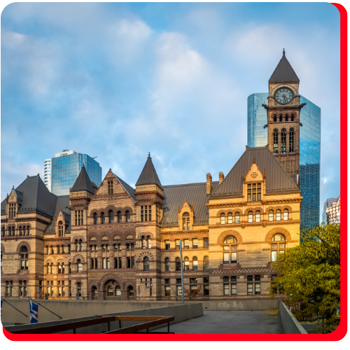Old City Hall in Toronto, Ontario, Canada, featuring restored historic stone facade and clock tower, with modern skyscrapers in the background under a clear morning sky. Old City Hall in Toronto, Ontario, Canada, featuring restored historic stone facade and clock tower, with modern skyscrapers in the background under a clear morning sky.