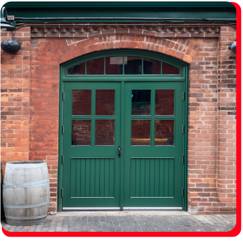Restored heritage brick building facade in Toronto’s Distillery District, featuring a green double wooden door with glass panels and an adjacent wooden barrel. Restored heritage brick building facade in Toronto’s Distillery District, featuring a green double wooden door with glass panels and an adjacent wooden barrel.