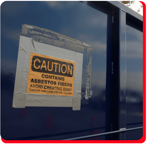 A yellow caution sign on a blue metal surface warns: Contains asbestos fibers. Avoid creating dust. Cancer and lung disease hazard—an important warning for professionals involved in commercial restoration, such as fire damage restoration, water damage restoration, commercial fire restoration, or commercial water damage restoration projects.