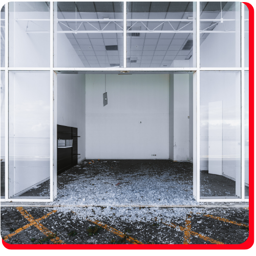 Vacant commercial storefront in Toronto, Ontario, with shattered glass scattered across the entrance, requiring professional damage assessment and restoration services.