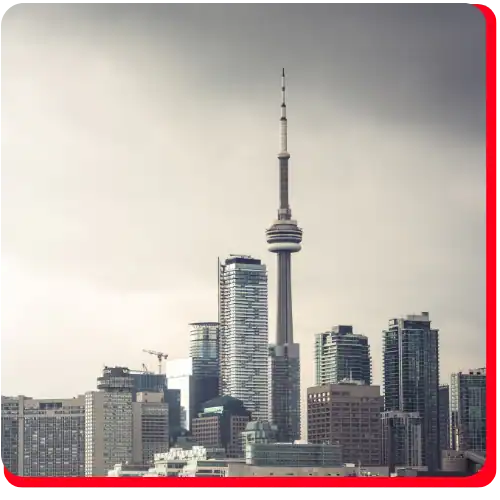 Toronto skyline featuring the iconic CN Tower surrounded by modern downtown high-rise buildings, showcasing the city’s recognizable urban architecture and landmark views in Ontario, Canada.