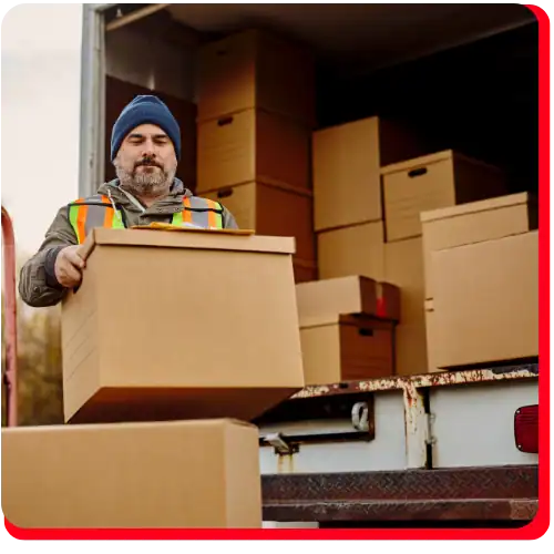 Impact Restore specialist carrying packed contents during commercial property restoration in Canada